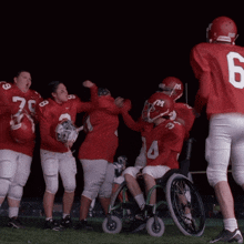 a group of football players in red uniforms with the number 6 on the back