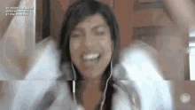 a woman wearing headphones is smiling and making a face .
