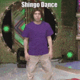 a man in a purple shirt is dancing with the words shingo dance behind him