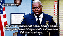 a police officer is talking about beyonce 's lemonade while standing in front of an american flag .