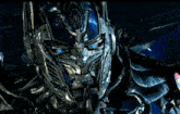 a close up of optimus prime 's face with blue eyes