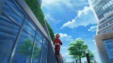 a man in a red shirt is running down a sidewalk in front of a building