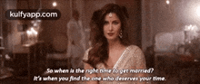 a woman in a white dress is standing in a room with a quote .