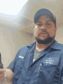a man wearing a blue shirt that says anthony