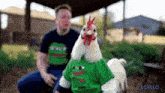 a rooster wearing a green shirt with a frog face on it