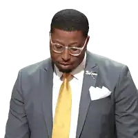 a man in a suit and tie with glasses on