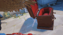 a coffin with a red lining is open and sitting on the ground