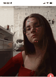 a phone screen shows a girl with the word cute written on her face