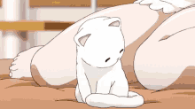 a cartoon cat is laying on a bed next to a woman 's legs