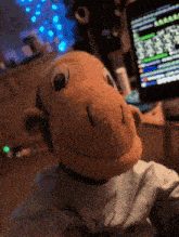 a stuffed monkey is sitting in front of a computer