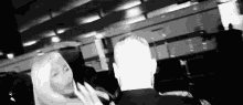 a black and white photo of a man and woman standing next to each other .
