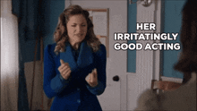 a woman in a blue coat with the words her irritatingly good acting behind her