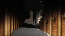 a man in a tuxedo stands in a dark room