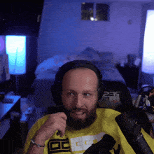a man wearing headphones and a yellow shirt with the number 235 on the back