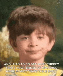 a young boy is smiling and talking about turkey .