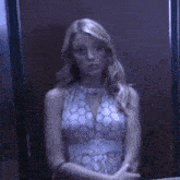 a woman in a white dress is standing in front of a mirror .