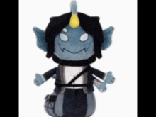 a stuffed toy that looks like a monster with a horn on its head