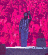 a man with a beard is standing on stage in front of a crowd