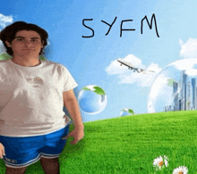 a man in a white shirt and blue shorts is standing in a field with the word syfm written on it