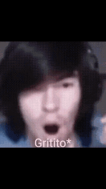 a close up of a person 's face with the word gritito on the bottom left
