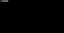 a man in a suit is standing next to a man in a black shirt in a rear view mirror .