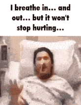 a man is laying in a hospital bed with a cigarette in his mouth