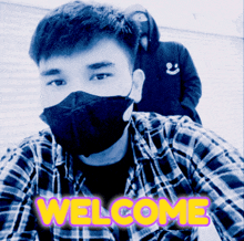 a man in a plaid shirt wearing a face mask with the word welcome written on the bottom