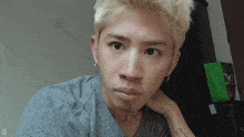 a man with a tattoo on his wrist that says " i love you " looks at the camera