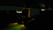 a scania truck is lit up at night