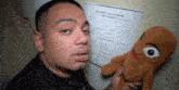 a man holding a stuffed animal in front of a job application