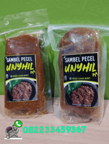 two bags of sambel pecel unyhil sitting on a table