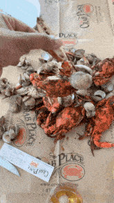 a person is holding a piece of paper that says the crab place on it