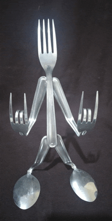 a person made out of forks and spoons making a rock sign
