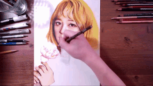 a person is drawing a picture of a girl with yellow hair and a flower