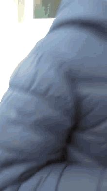a close up of a person 's arm with a blue shirt on