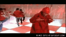 a group of people are dancing on a red and white checkered floor ..