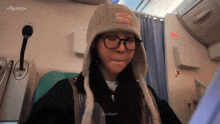 a girl wearing glasses and a hat with the word byulog on the bottom right