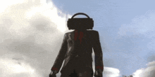 a man in a suit and tie is wearing headphones on his head and holding a briefcase .