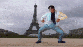 a painting of a man dancing in front of the eiffel tower with the letters viggle.ai below him