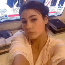 a woman is taking a selfie in front of a tv that says intel on it