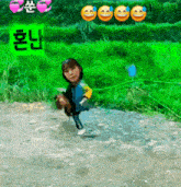 a girl is standing in a muddy field with smiley faces behind her and a green background