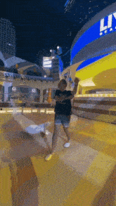 a man is dancing in front of a building that says ' lincoln ' on it