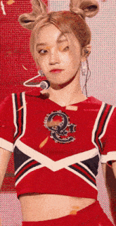 a cheerleader wearing a red shirt with the number 9 on the front