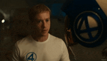 a man wearing a white t-shirt with a blue 4 on it