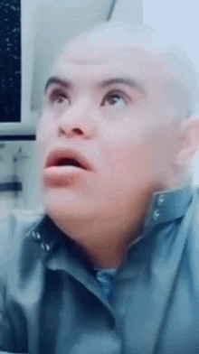 a close up of a man 's face with a shocked look on his face