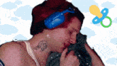 a man with a tattoo on his neck and a pacifier on his head