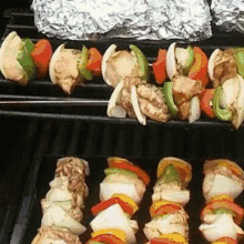 a grill with a bunch of skewers of food on it