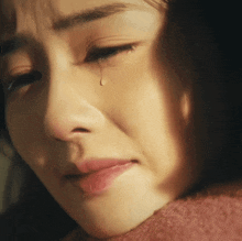 a woman crying with a tear coming out of her eye