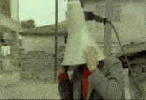 a man is holding a megaphone in front of his head