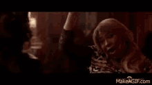 a man and a woman are dancing in a dark room .
